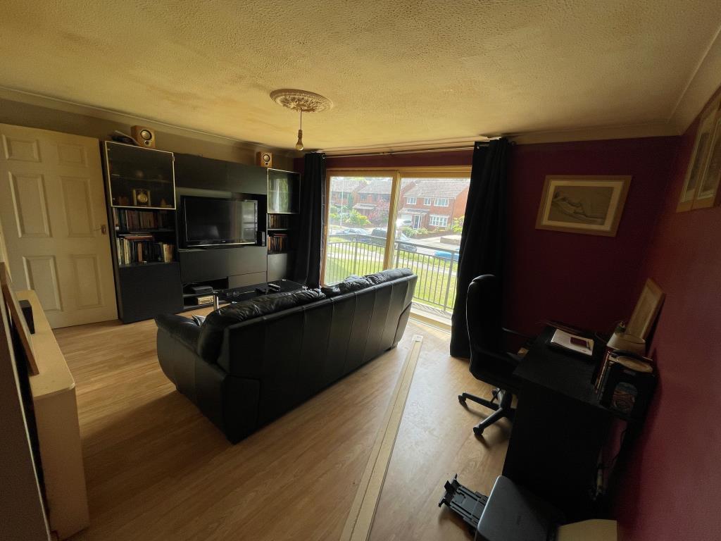 Lot: 104 - TWO-BEDROOM MAISONETTE WITH GARAGE - Living room with access to balcony